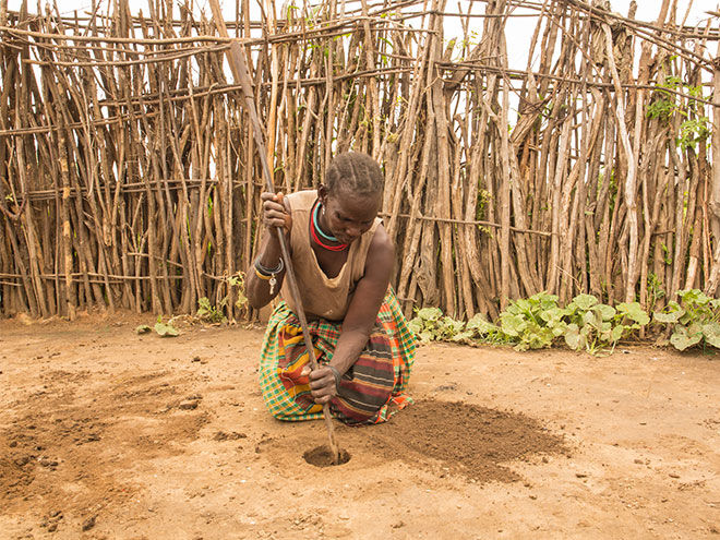 Digging hole for periods in Uganda