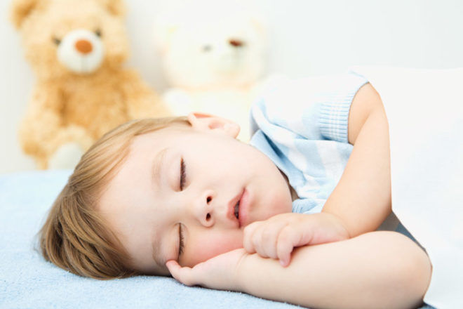 Sleeping baby boy and teddy bear
