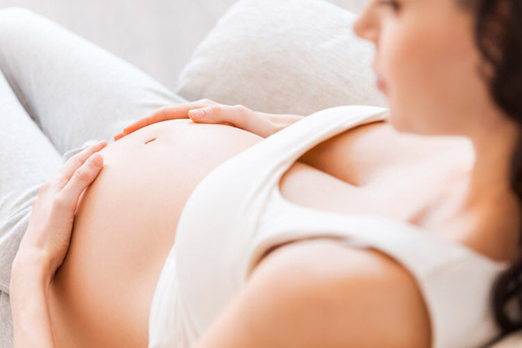 Pregnant woman feeling baby move
