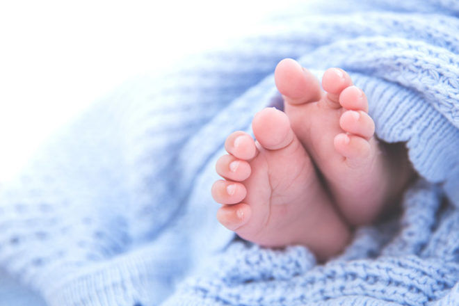 Baby feet in blue blanket