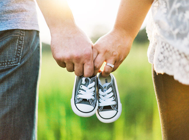 Holding baby shoes pregnancy announcement