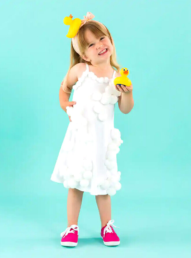Bubble bath toddler costume worn by young girl holding a rubber duck