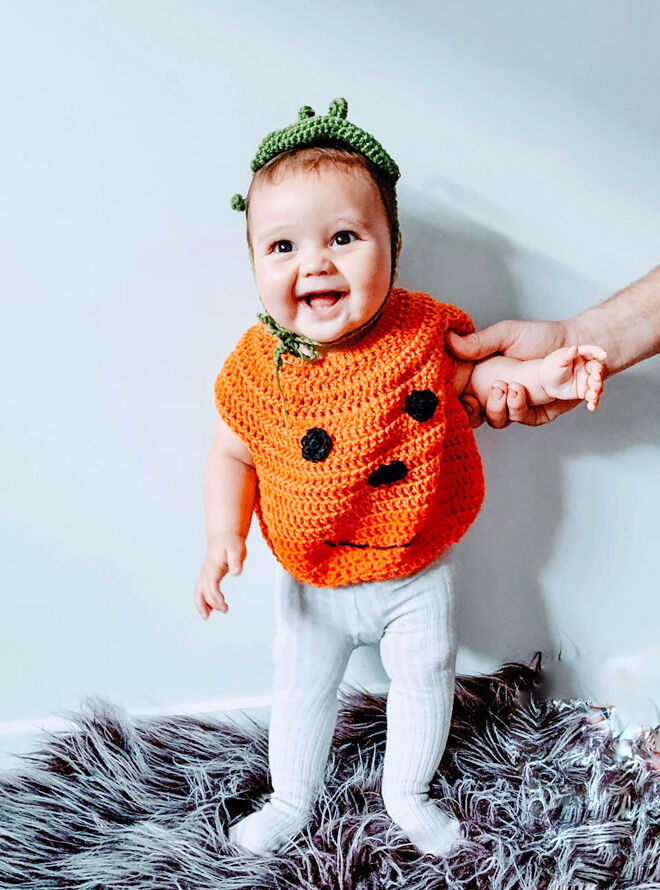 Crocheted pumpkin toddler Halloween costume worn by young child