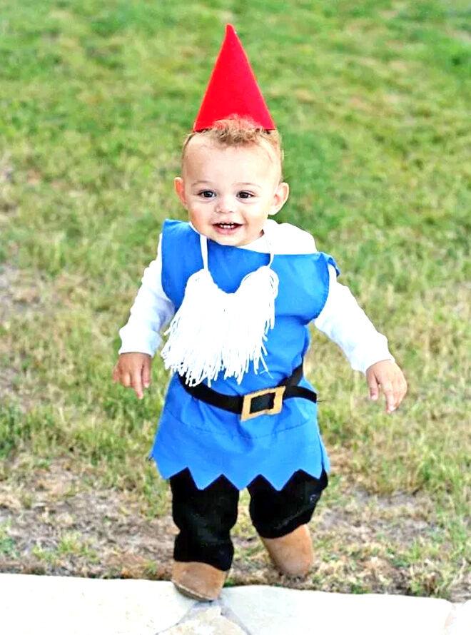 Small boy dressed up as a Garden gnome for Halloween in a toddler costume