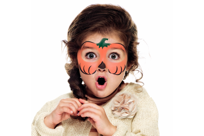 Young girl wearing pumpkin mask face paint,