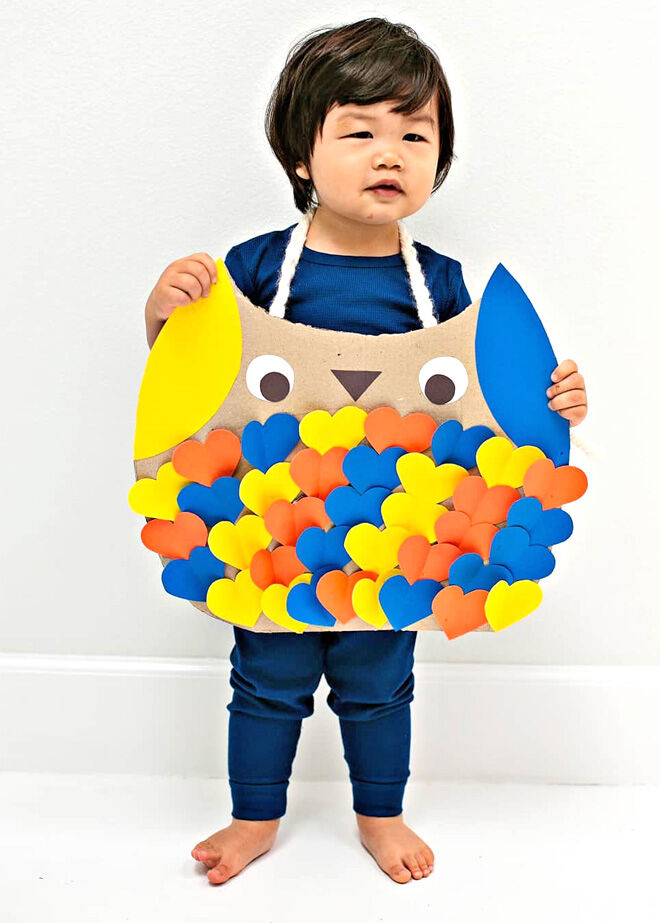 Easy cardboard owl costume for Halloween worn by toddler