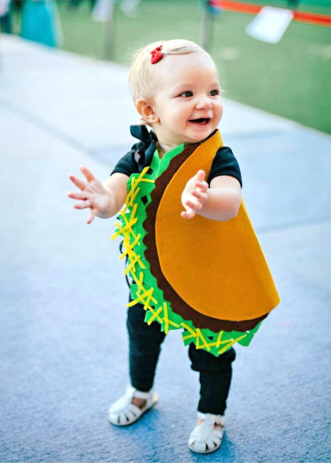 Young child wearing a Taco felt costume for Halloween