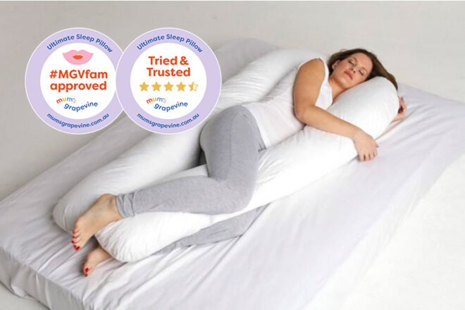 Ultimate Sleep full body maternity pillow showing a pregnant mum lying in the middle of the body pillow relaxed and fully supported