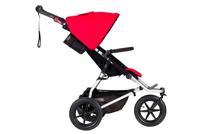 Side view of Mountain Buggy Urban Jungle travel system stroller showing all-terrain wheels, lightweight frame and canopy and seat pad in Red colour option. 