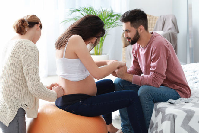 Pregnant couple at home with doula