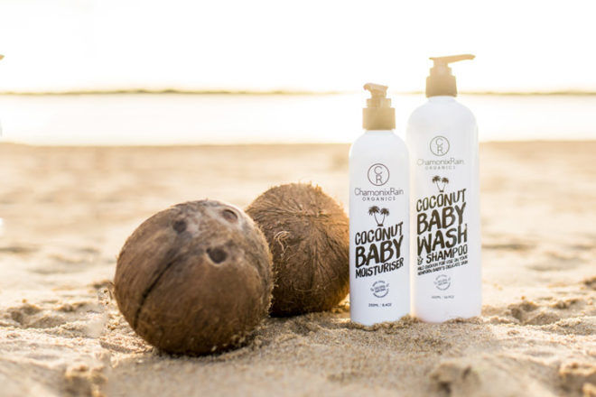 Front view of ChamonixRain Organics packing showing Baby Moisturiser and Baby Wash & Shampoo next to coconuts, the hero ingredient.