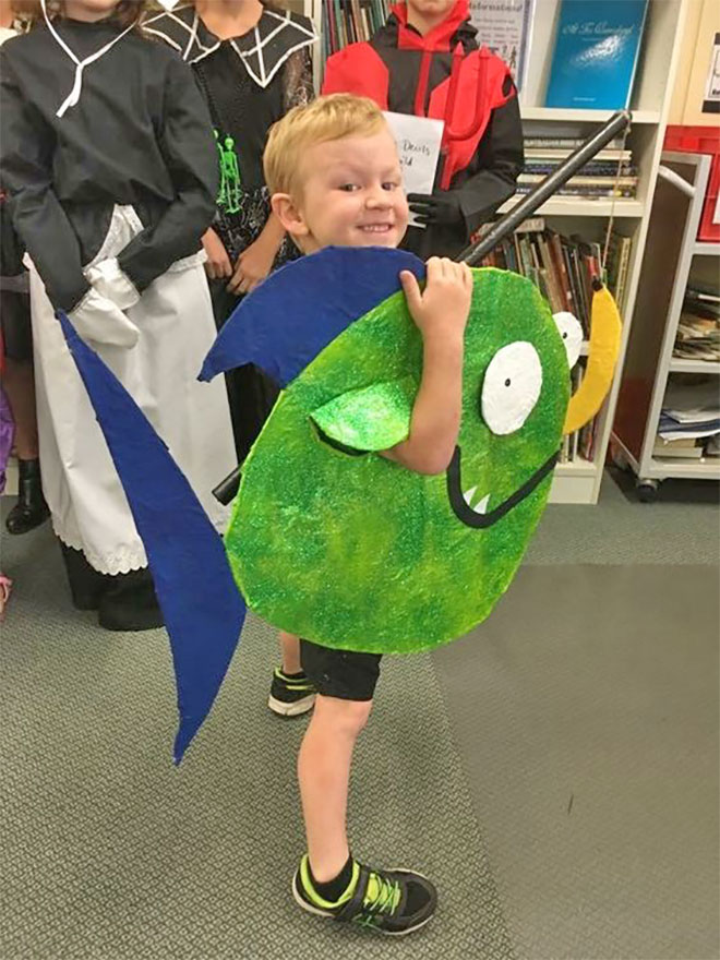 Photo showing a little boy dressed as the Pirrahna character from the book Pirrahnas Don't Eat Bananas