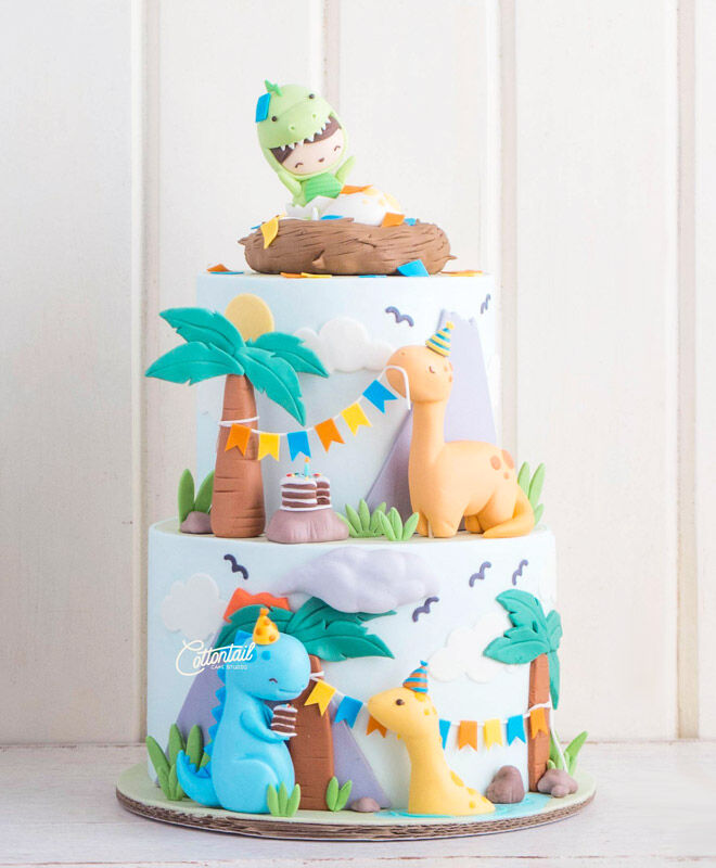 Colourful tiered 3D dinosaur cake