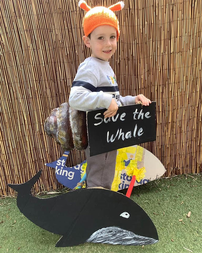 Photo showing a little boy dressed as the Snail and the Whale the book 'The Snail And The Whale' 