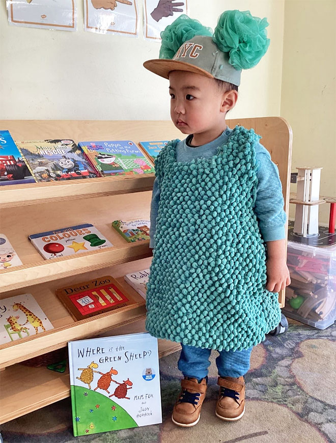 Photo showing a little boy dressed as the Green Sheep from the book 'Where is the Green Sheep' 
