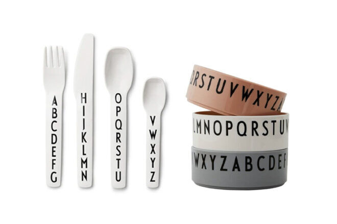 Nordic Design Kids' Cutlery Set next to their matching bowls showing the cute educational alphabetic designs.