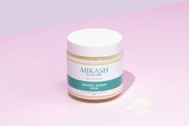 Mikash Baby Barrier Balm showing the front side of the product and a smear of the cream to show the consistency. 