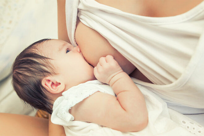 Woman breastfeeding baby stk