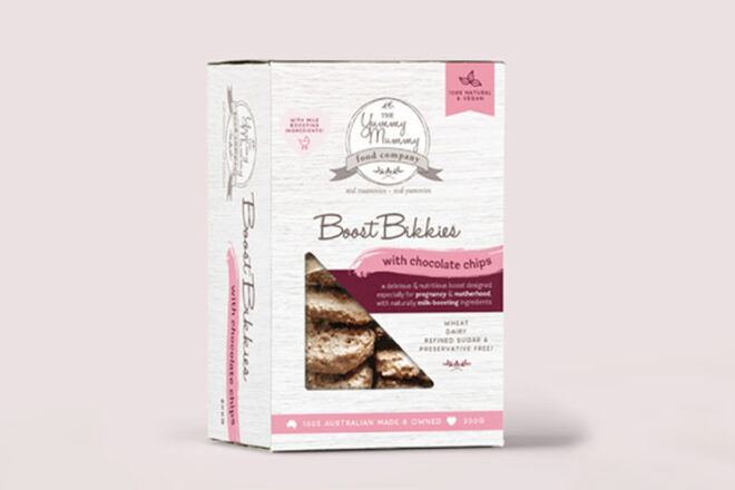 The Yummy Mummy Food Company Boost Bikkies are shown packaged in a box with a front and side view. The box contain information on the ingredients and nutritional values of the choc-chip biscuits inside. 