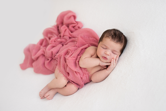 Newborn baby sleeping pink
