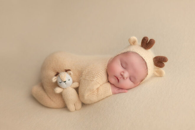 Autumn Baby Names newborn dressed in fawn suit