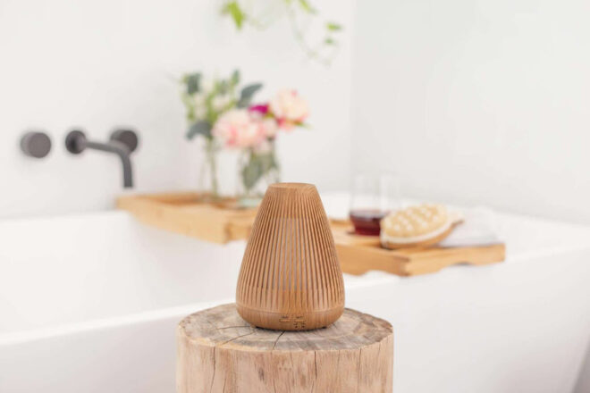 Close up showing the Lively Living Aroma Flare diffuser in a relaxing bathroom setting, making for a self-care gift for new mums.