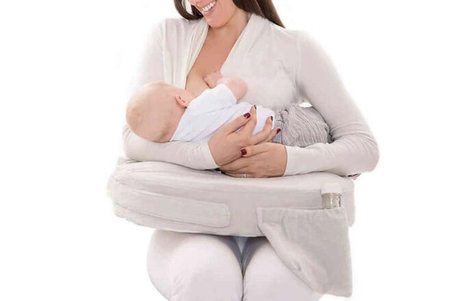 My Brest Friend Nursing Pillow showing front view of baby feeding on it and drink bottle in pocket. A practical baby shower gift for new mums.