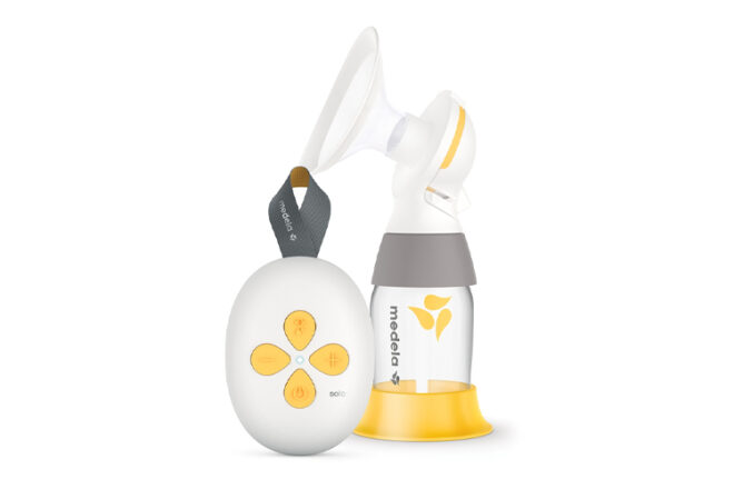 Medela Swing Maxi single Electric Breast Pump showing the small size of the pump unit compared to the bottle and flange 