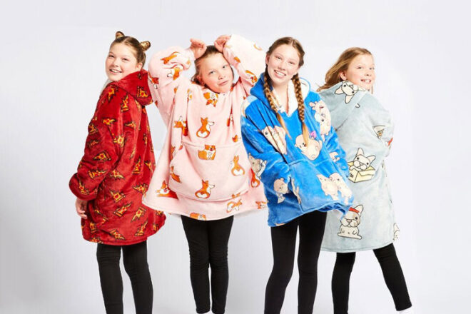 Back, side and front views of girls wearing kids' Oodies showing pockets and different fun designs. 