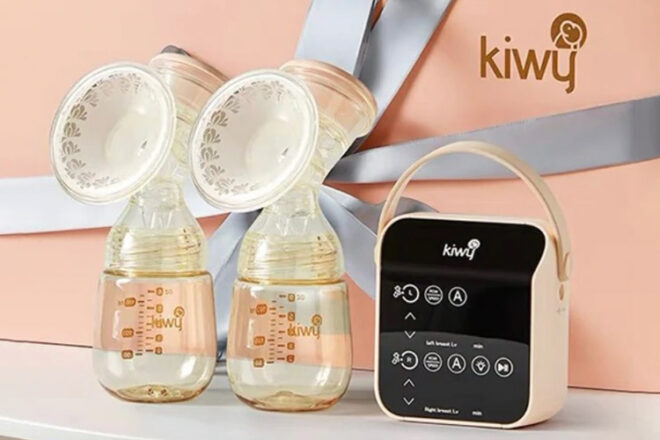 Omababy Kiwy 3-in-1 portable breast pump sitting on a bench top. Showingn the size and shape of the pump flanges and the controls on the pump unit