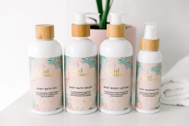 Line up of Kind Coconuts Infant skincare bottles showing size comparison as well as bamboo lids and pretty label.