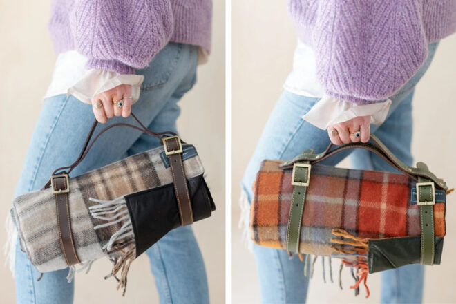 Close up views of lady holding folded The Tarten Blanket Co tartan picnic blankets in two different colourways for comparison, highlighting the buckle straps, carry handle and waterproof lining. 
