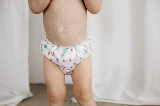 Close up front view of toddler wearing the Bubba Bump swim bottom, showing the acorn print.