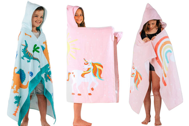 Three children wearing Novange Hooded Baby Bath Towels showing hood in use, length and coverage of towel as well as showcasing designs for boys and girls in dinosaur and unicorn. 