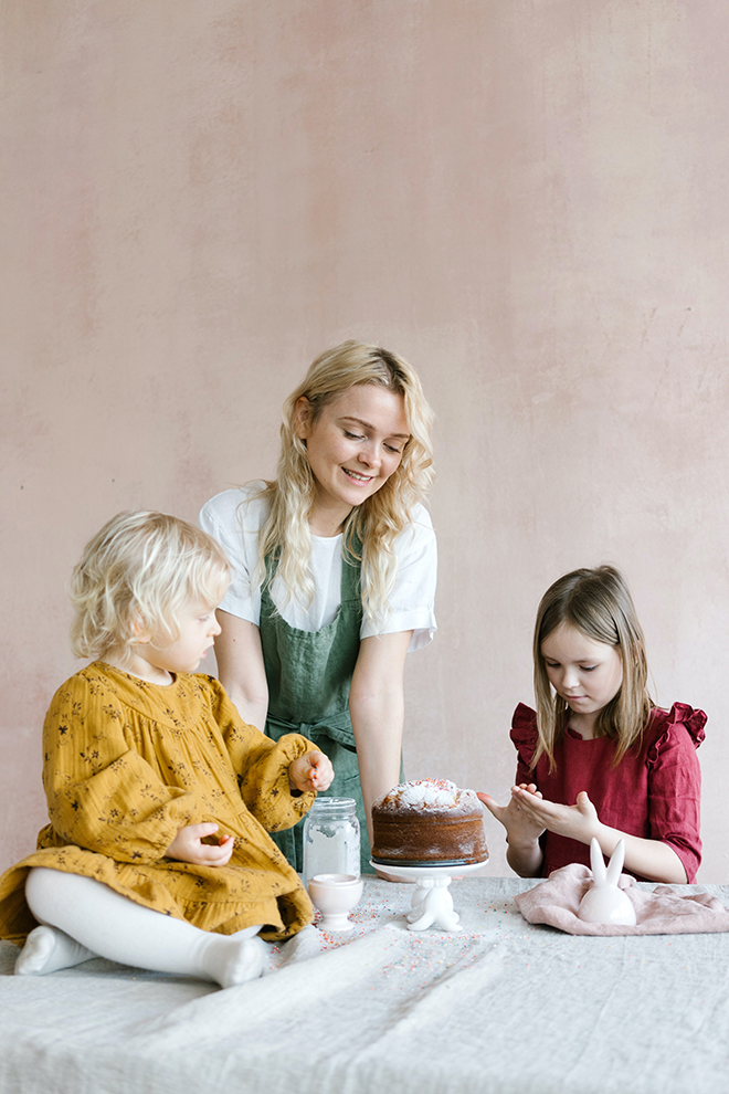 Mother and two daughters making a cake for Easter