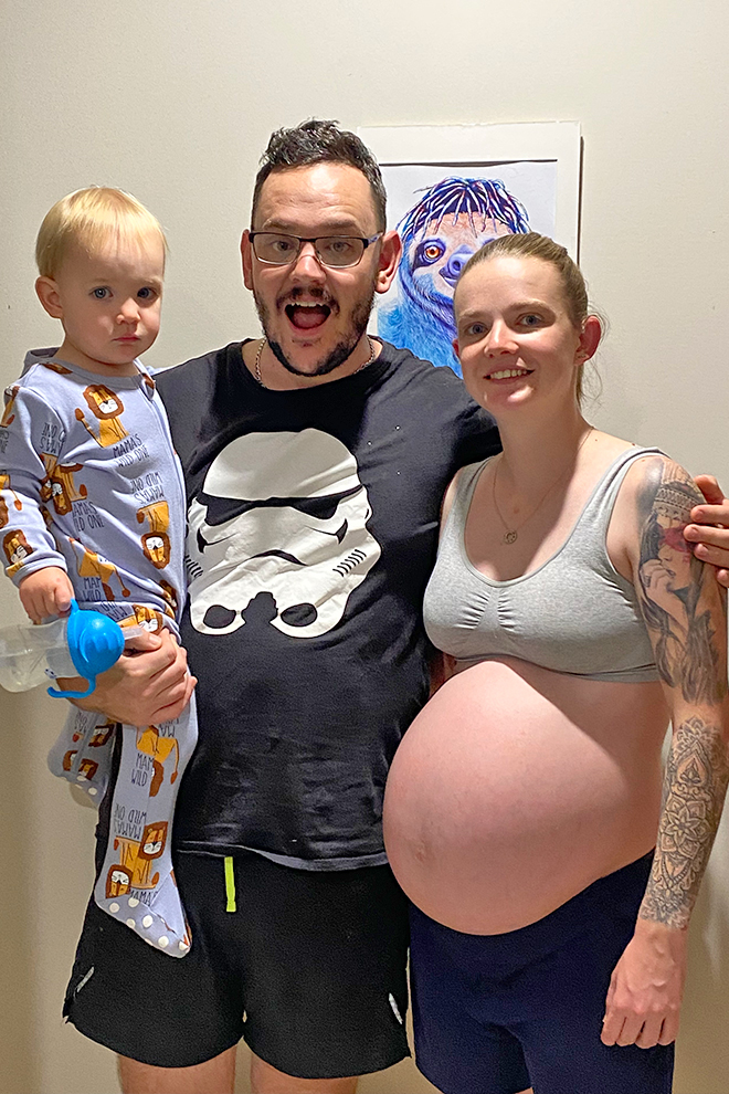 Family portrait of a pregnant Laura O and her partner and first son 