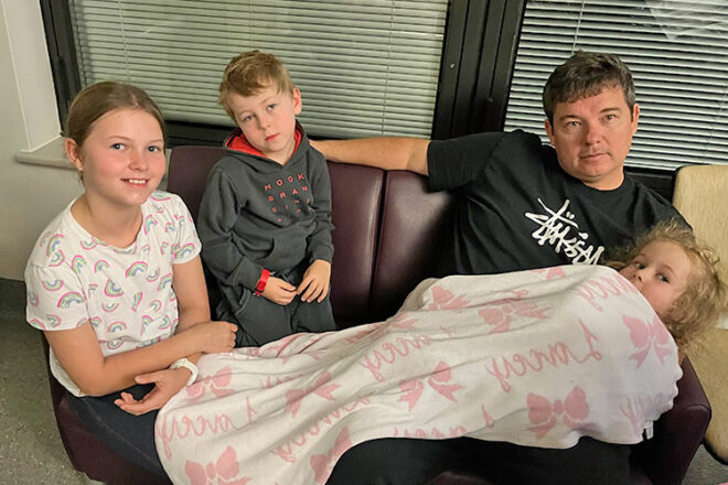 Mindy's husband and three other children waiting for their new brother to be born at the hospital