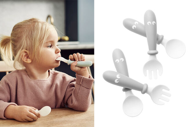 Toddler using Babt Bjorn baby cutlery next to two sets of spoons and forks showing the eye design and rounded shape