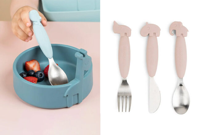 Toddler using Done by Deer baby cutlery next to a set of spoons, forks and knives showing matching colours and size