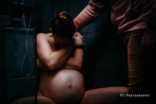 Pregnant mother sitting in shower