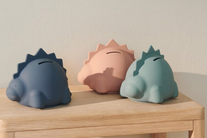 Liewood showing Palam money boxes in the shapes of three dinosaurs in blue, teal and pink 