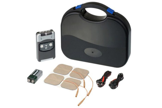 Metron showing ProTens machine in grey with black large carry case with cords, batteries and skin panels