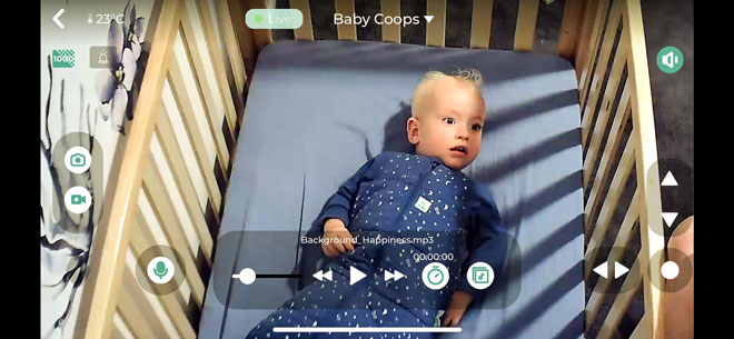Baby lying in cot showing the Oricom Dual Camera Baby Monitor screen quality