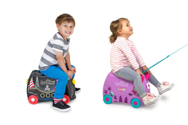 Two kids riding Trunki ride-on suitcases