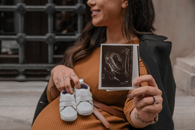 Pregnancy Announcement ultrasound photo and baby shoes