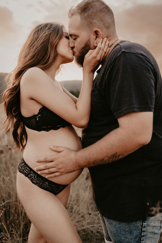 Ruby and her partner embrace in maternity photoshoot