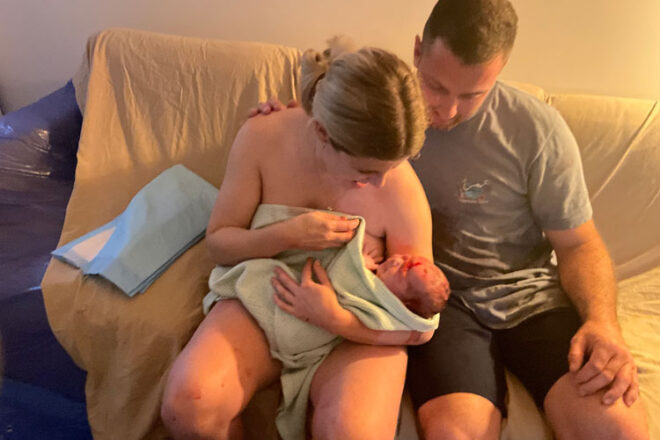 Mum and Dad holding baby after home birth