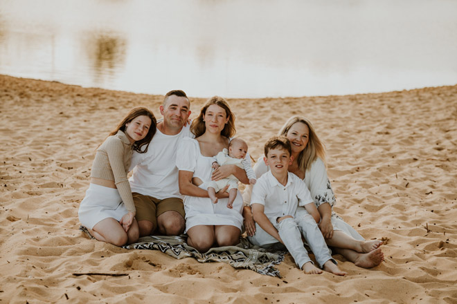 A family portrait on the beach with Anita, her partner and their four children.
