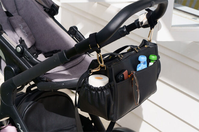 Arrived Leather Pram Caddy showing use on a stroller whilst full on baby and mum items