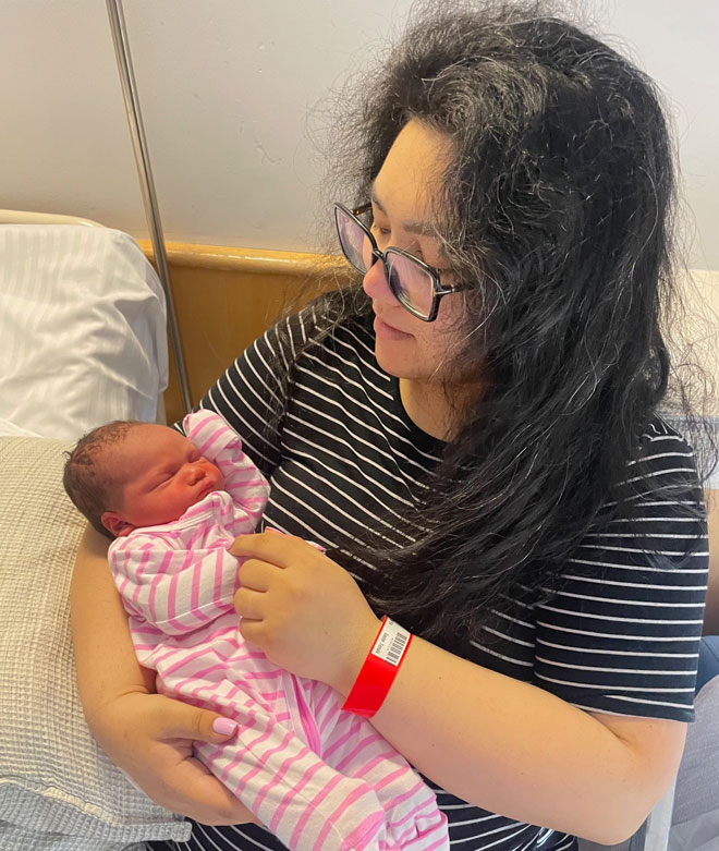 Mum Emily holding newborn Charlotte
